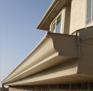 New seamless beige aluminum eavestrough installed on a stucco home in North York